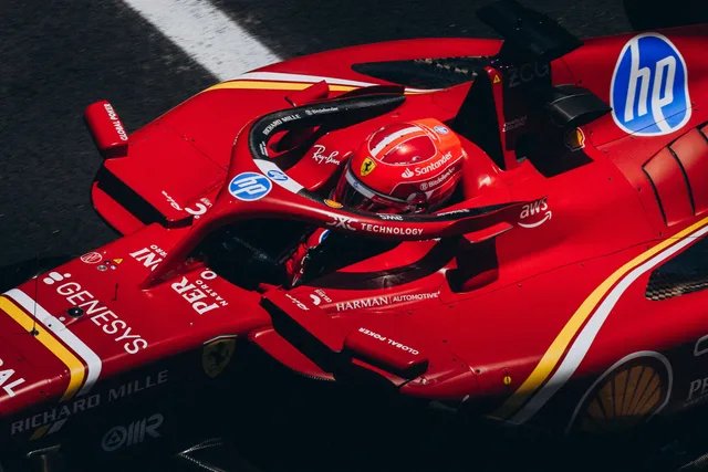 High-speed red racing car zooming down the track, showcasing logos and driver focus. Valuing sponsorship opportunities